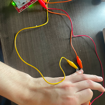Connecting the scissors to two alligator clips simultaneously, one on each blade, testing whether holding the scissors open or closed changes the interaction behaviour.