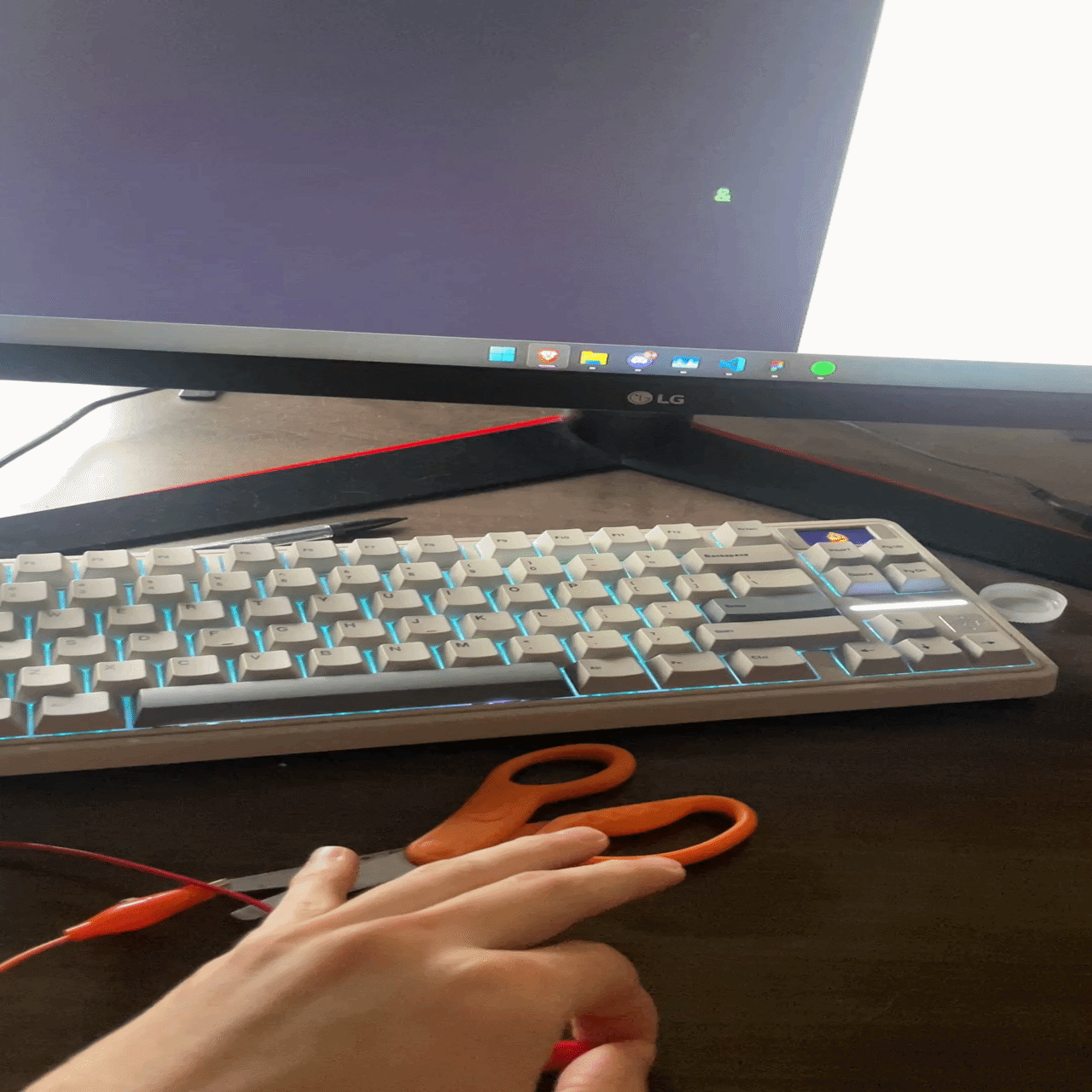 Iterating on the scissors interaction by adjusting clip placement and grip position, refining which part of the tool most reliably triggers the Makey Makey.